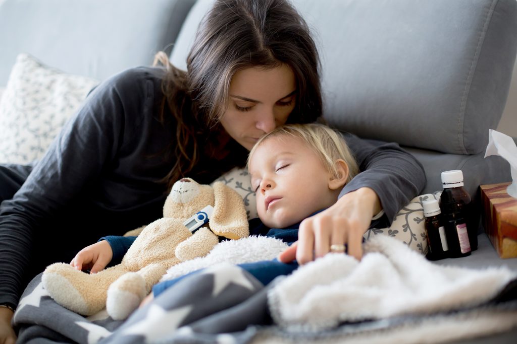 Blond toddler boy, sleeping on the couch in living room